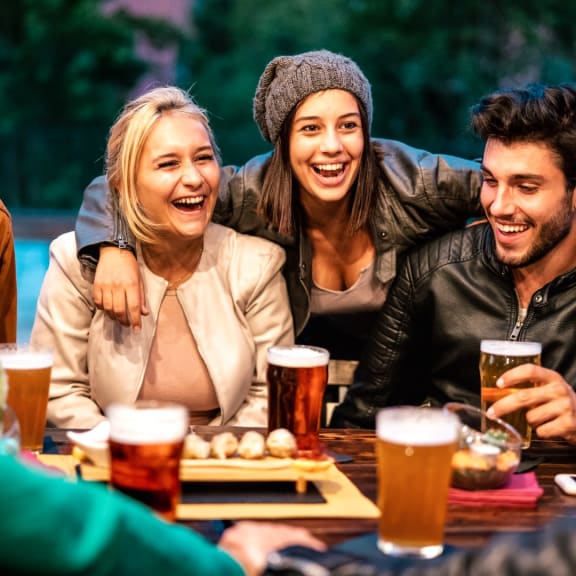 Friends Having Drinks Together Smiling