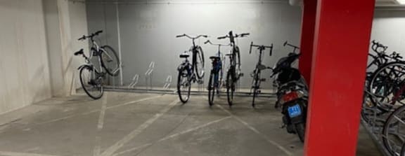 A bike parking area with bikes parked in a row.