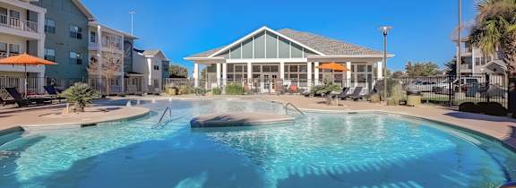 A large house with a pool in front.