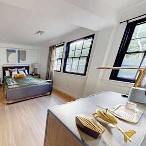 Spacious bedroom with wood flooring and dual windows at The Overlook Apartments, Weymouth