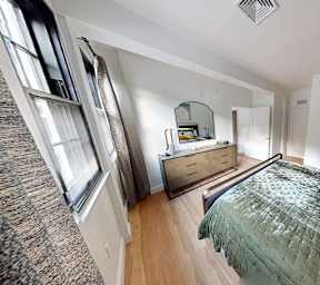 Bedroom with two beds and sage green bedding at The Overlook Apartments, Weymouth, MA 02188
