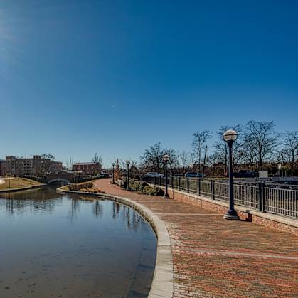 a park with a pond and a city in the background at North Market South Carroll, Maryland