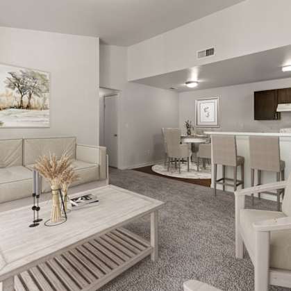 A living room with a couch, chairs, and a coffee table.