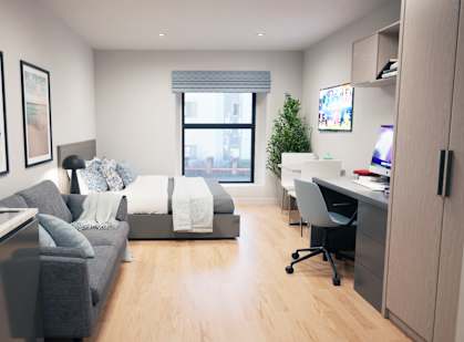 a bedroom with a bed and a desk in a room