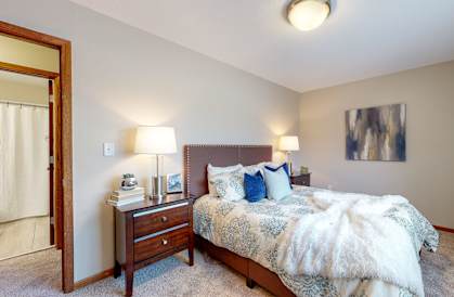 a bedroom with a bed and two night stands