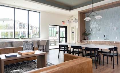 a dining room with tables and chairs and a large window