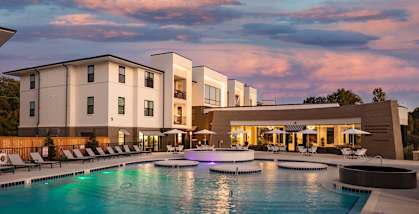 a large swimming pool in front of a hotel at Esplanade District Apartments, Little Rock