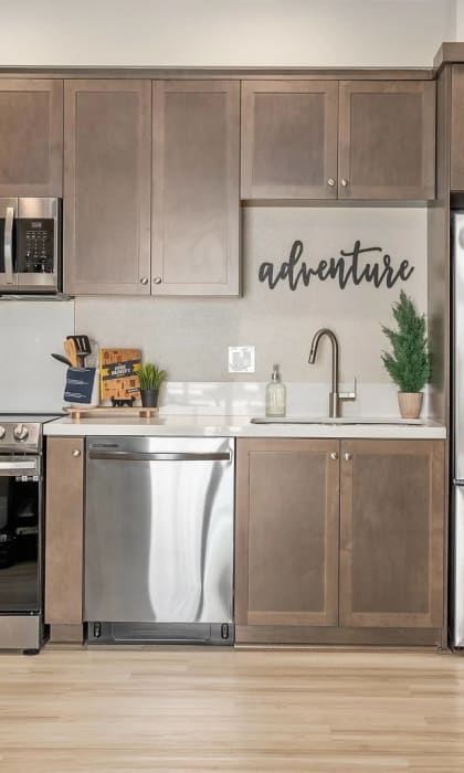 a kitchen with stainless steel appliances and a refrigerator