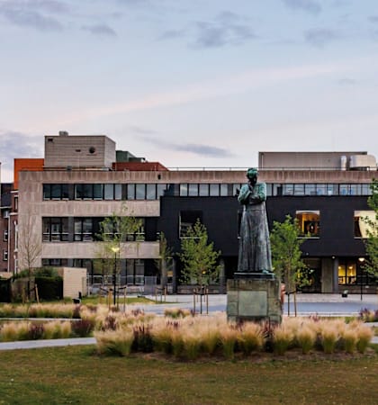 A modern building with a fountain in front of it.