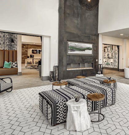 A modern living room with a fireplace and patterned floor tiles at Arise Riverside Apartments, Austin, TX, 78741