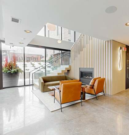 A modern living room with a fireplace and a glass door.