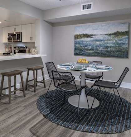 an open kitchen and dining area with a table and chairs