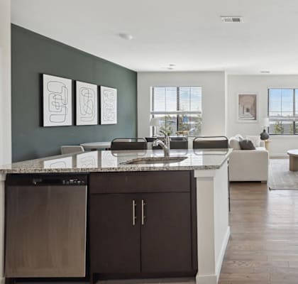 an open kitchen and living room with a sink and a table