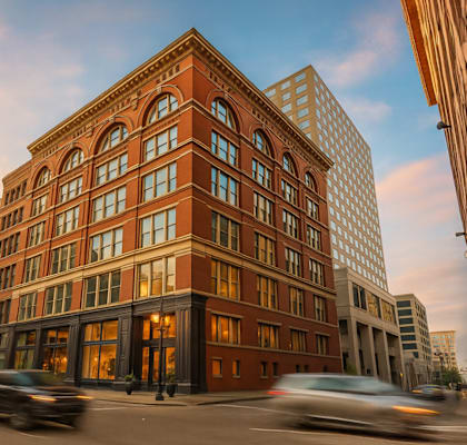 A red brick building with a street in front of it.