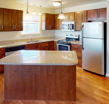 a kitchen with a island and a refrigerator