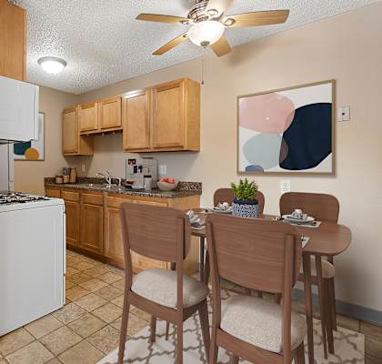 an open kitchen and dining area with a dining table and chairs