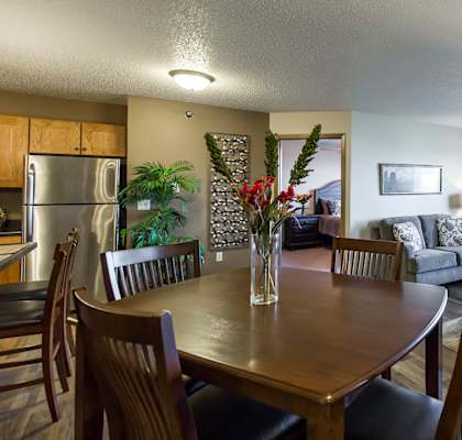 the view of a living room and dining room with a table and chairs
