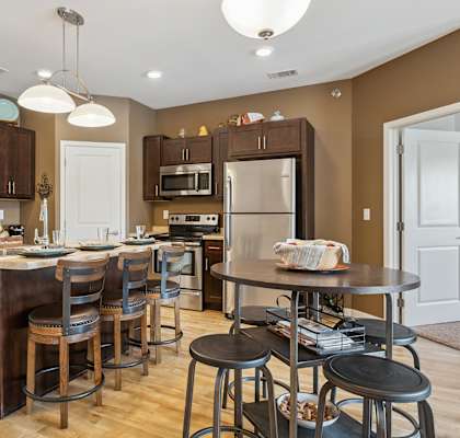 A kitchen with brown cabinets and a white island.