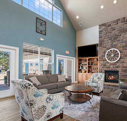 a living room with couches and a clock on the wall
