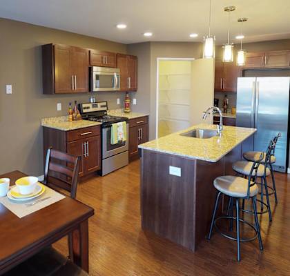 a kitchen and dining room with a wooden table