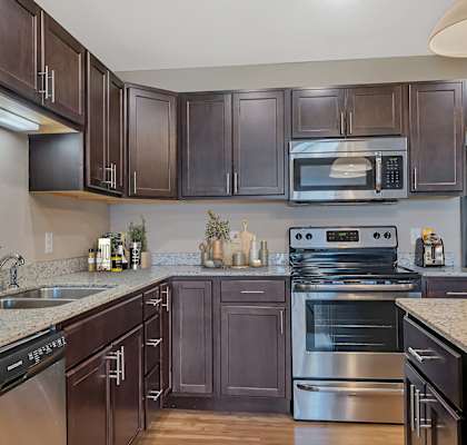 a modern kitchen with stainless steel appliances and granite counter tops