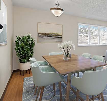 a living room with a table and chairs and a couch