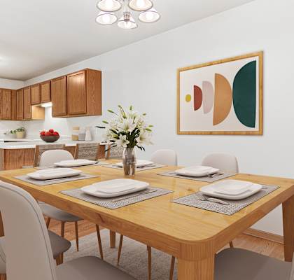 a dining room with a wooden table and chairs