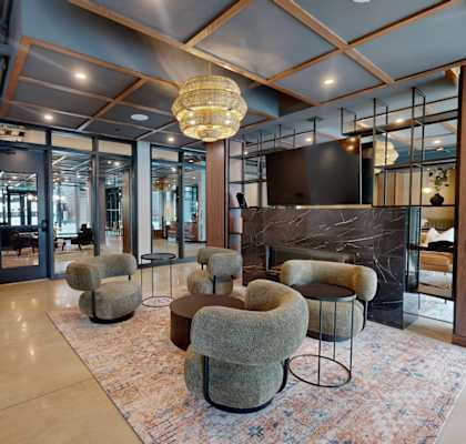 A modern living room with a fireplace and a rug.