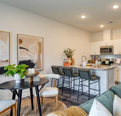 A modern kitchen with a dining table and chairs.