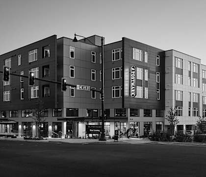A black and white image of a multi-story apartment building.