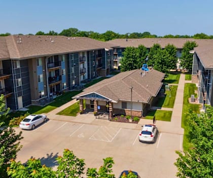 A Parking Lot In Front Of a Building  at Capitol Grove Apartments, Des Moines