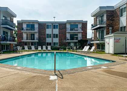 A swimming pool in front of apartment buildings.