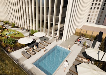 A person is standing in a pool on a rooftop patio.