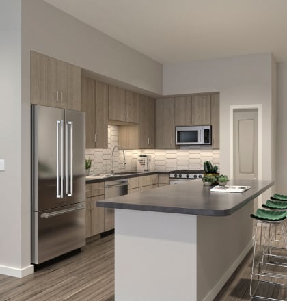 an apartment kitchen with stainless steel appliances and a large island