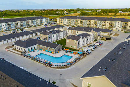 an aerial view of an apartment complex with a swimming pool at Forge65, Iowa, 50327