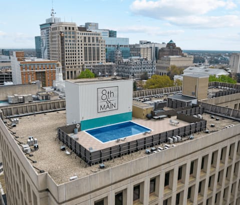 A large building with a pool on the roof.