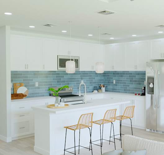 A kitchen with a blue backsplash and white cabinets.
