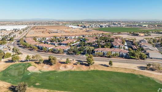 an aerial view of a city with houses and a golf course