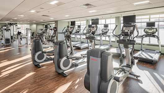 a gym filled with cardio equipment and exercise bikes
