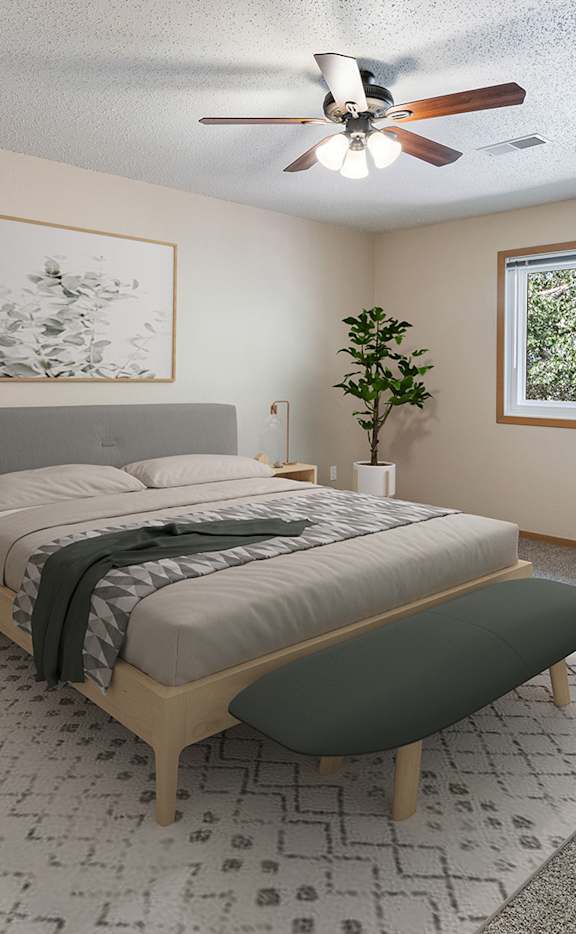 a bedroom with a bed and a ceiling fan