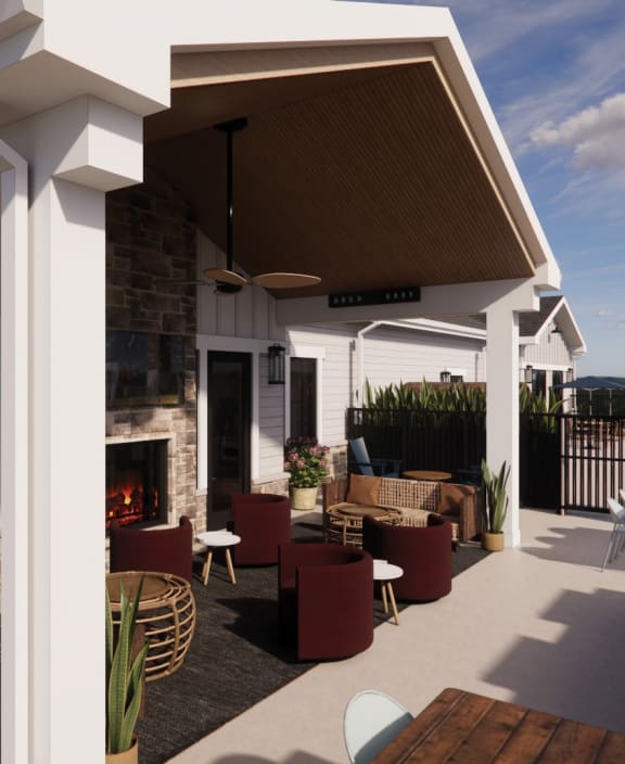 a covered patio with furniture and a fireplace at Sandhill Parkway Townhomes Apartments, East Bethel, Minnesota