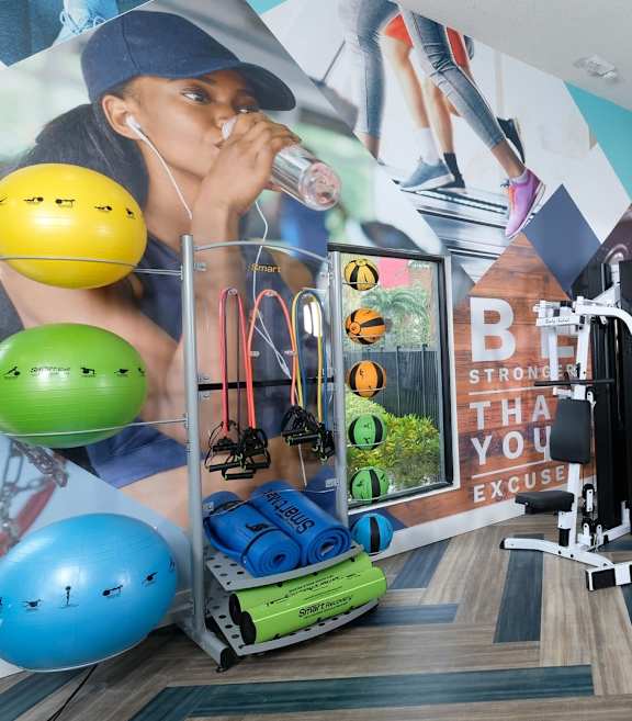 A foosball table is in the middle of a room with a couch and a television.