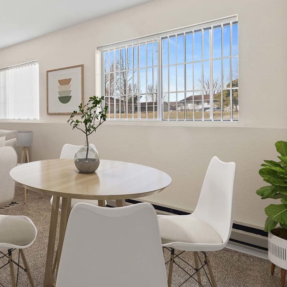 a living room with a table and chairs