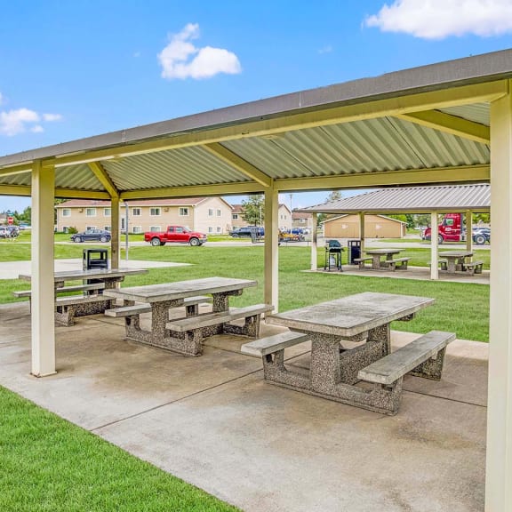 a picnic area with benches and a pavilion