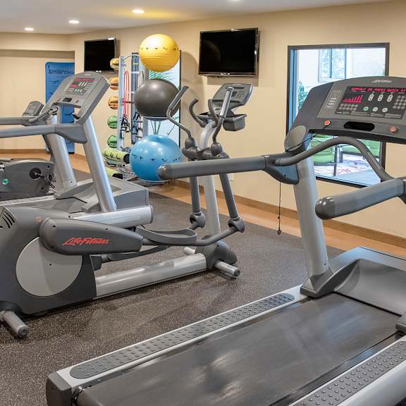 a room with two treadmills and two exercise bikes