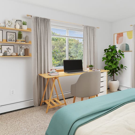 a bedroom with a bed and a desk with a computer