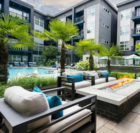 A patio with a table and chairs surrounded by buildings.