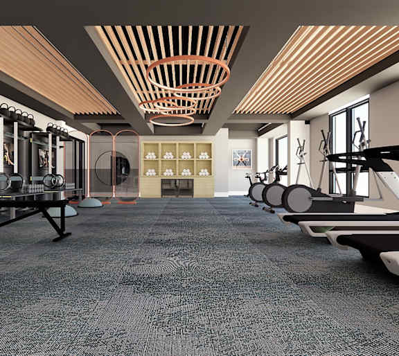 A gym with a variety of equipment including treadmills, weights, and exercise machines.