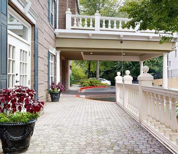 A white balustrade runs along the edge of a brick patio.