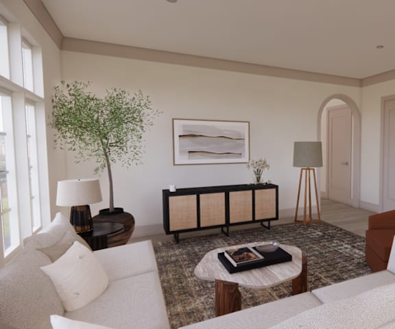 a living room with white furniture and a rug